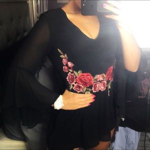 A black She+Sky brand romper w/ embroidered roses